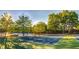 Scenic tennis courts with lake backdrop and professional lighting at 250 Martin Ridge Ct, Roswell, GA 30076
