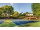 Well-maintained community tennis courts with lighting, a clubhouse, and lots of mature trees surrounding the area at 250 Martin Ridge Ct, Roswell, GA 30076