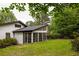 Home exterior with a screened-in porch and a lush lawn with mature trees creating a private outdoor space at 3063 Leafwood Dr, Decatur, GA 30033