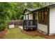 Home back exterior with a private deck area, small deck, landscaping and a generator at 3063 Leafwood Dr, Decatur, GA 30033
