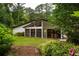 Lush backyard featuring a spacious lawn, mature trees, and modern architectural home design at 3063 Leafwood Dr, Decatur, GA 30033