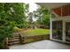 Lush backyard with a patio, garden, and stairs leading to a seating area at 3063 Leafwood Dr, Decatur, GA 30033