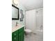 Charming bathroom with white subway tile shower, green vanity, and stylish fixtures at 3063 Leafwood Dr, Decatur, GA 30033