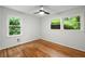 Bright bedroom with hardwood floors, large windows, and views of lush greenery at 3063 Leafwood Dr, Decatur, GA 30033