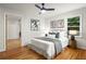 Inviting bedroom with hardwood floors, a cozy bed, stylish decor, and a view into an adjacent room at 3063 Leafwood Dr, Decatur, GA 30033