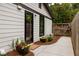 Charming home exterior with a black trimmed door and window and landscaped with potted flowers at 3063 Leafwood Dr, Decatur, GA 30033