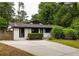 Charming single story home features a long driveway and mature landscaping at 3063 Leafwood Dr, Decatur, GA 30033