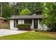 Charming home featuring a well-manicured lawn, inviting entrance, and a blend of brick and siding at 3063 Leafwood Dr, Decatur, GA 30033