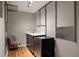 Cozy kitchenette featuring a sink, sleek cabinetry, a mini-fridge, and a modern aesthetic in a compact space at 3063 Leafwood Dr, Decatur, GA 30033
