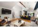 Bright, open living room flows into kitchen with hardwood floors, vaulted ceiling, and modern lighting fixtures at 3063 Leafwood Dr, Decatur, GA 30033