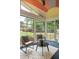 Inviting sunroom with lots of natural light, offering a tranquil view of the lush backyard and manicured lawn at 3063 Leafwood Dr, Decatur, GA 30033