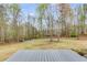 Enjoy the expansive backyard with mature trees, offering a peaceful retreat with fire pit at 3642 Falls Trl, Winston, GA 30187