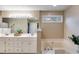 A bathroom with a soaking tub, and a double vanity with white cabinets and lots of counter space at 3642 Falls Trl, Winston, GA 30187