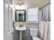 Cozy bathroom features a pedestal sink, toilet, and shower with stylish curtain at 3642 Falls Trl, Winston, GA 30187