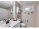 Neutral bathroom featuring a white vanity with black hardware and decorative wall accents at 3642 Falls Trl, Winston, GA 30187