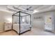 A bright bedroom with a four-poster bed, tray ceilings, and a door to a screened porch at 3642 Falls Trl, Winston, GA 30187