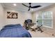 Bedroom with a bed and desk/work area with a large window at 3642 Falls Trl, Winston, GA 30187