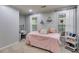 Cozy bedroom with two windows, a desk, and a comfortable bed with decorative pillows at 3642 Falls Trl, Winston, GA 30187