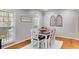 Bright dining area with hardwood floors, decorative windows, and a six-chair dining set at 3642 Falls Trl, Winston, GA 30187
