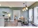 Charming dining room with stylish lighting fixture, adjacent to a living area at 3642 Falls Trl, Winston, GA 30187