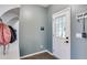Functional entryway with storage hooks and a door with a window for natural light at 3642 Falls Trl, Winston, GA 30187