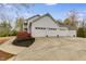 Home featuring a three car garage, white siding, and a curved concrete driveway at 3642 Falls Trl, Winston, GA 30187