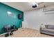Converted garage space featuring a turquoise accent wall, seating, and minimalist decor at 3642 Falls Trl, Winston, GA 30187