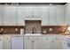 Close up of traditional style kitchen with custom cabinets and a tiled backsplash at 3642 Falls Trl, Winston, GA 30187