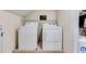 Laundry room with side by side washer and dryer units and storage shelf at 3642 Falls Trl, Winston, GA 30187