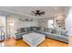 Comfortable living room with a large sectional couch, a ceiling fan, and hardwood floors at 3642 Falls Trl, Winston, GA 30187