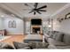 Cozy living room with a fireplace, a large TV, a ceiling fan and hardwood flooring at 3642 Falls Trl, Winston, GA 30187