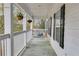 A covered porch with a porch swing and hanging flower baskets at 3642 Falls Trl, Winston, GA 30187