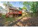 Backyard with mature trees, wooden fence, and deck at 1248 Falling Water Se Dr, Smyrna, GA 30080