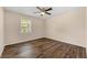 Bedroom with hardwood floors, ceiling fan, and a window offering a view to the outside at 1248 Falling Water Se Dr, Smyrna, GA 30080