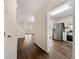 Open hallway leading to a modern kitchen and a bright living area, showcasing the home's layout at 1248 Falling Water Se Dr, Smyrna, GA 30080