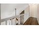 Second floor hallway featuring hardwood floors and view of living room fireplace at 1248 Falling Water Se Dr, Smyrna, GA 30080