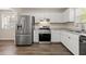 Well-equipped kitchen with stainless steel appliances, white cabinets, and elegant countertops, perfect for cooking at 1248 Falling Water Se Dr, Smyrna, GA 30080