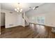 Bright living room featuring beautiful hardwood floors, a modern chandelier, and access to the backyard through glass doors at 1248 Falling Water Se Dr, Smyrna, GA 30080