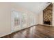 Bright living room with hardwood floors featuring stone fireplace and access to backyard at 1248 Falling Water Se Dr, Smyrna, GA 30080