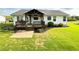 Large, level backyard with a covered deck, offering plenty of space for outdoor activities at 273 Crowe Springs Nw Rd, Cartersville, GA 30121