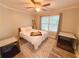 Comfortable bedroom with natural light, wood-look floors, and a ceiling fan at 273 Crowe Springs Nw Rd, Cartersville, GA 30121