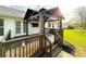 Cozy covered deck with railing, outdoor lighting, and TV at 273 Crowe Springs Nw Rd, Cartersville, GA 30121