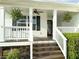 Inviting front porch with hanging plants, a ceiling fan, and fresh paint at 273 Crowe Springs Nw Rd, Cartersville, GA 30121