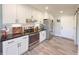 Bright kitchen with white cabinets, stainless steel appliances, and stone countertops at 273 Crowe Springs Nw Rd, Cartersville, GA 30121