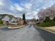 Gated entrance to a residential community with brick columns, iron gates, and beautifully landscaped grounds at 3455 Buffington Ln, Cumming, GA 30040