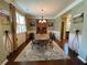Elegant dining room with stylish decor, chandelier, and large window at 3455 Buffington Ln, Cumming, GA 30040