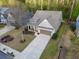 Charming home featuring a two-car garage, well-manicured lawn, and a cozy front porch, nestled in a wooded neighborhood at 3455 Buffington Ln, Cumming, GA 30040