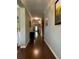 Hallway featuring hardwood floors, neutral colors, and decorative trim at 3455 Buffington Ln, Cumming, GA 30040