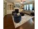 Stylish living room with fireplace, built-in shelving, hardwood floors, and comfortable seating at 3455 Buffington Ln, Cumming, GA 30040