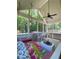 Relaxing screened porch with porch swing, white furniture, brick floors at 3455 Buffington Ln, Cumming, GA 30040